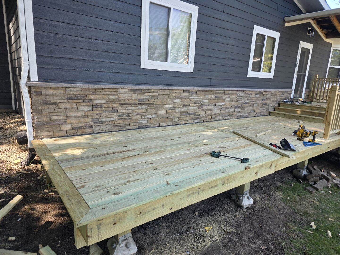 Newly installed deck surface along the side of a home