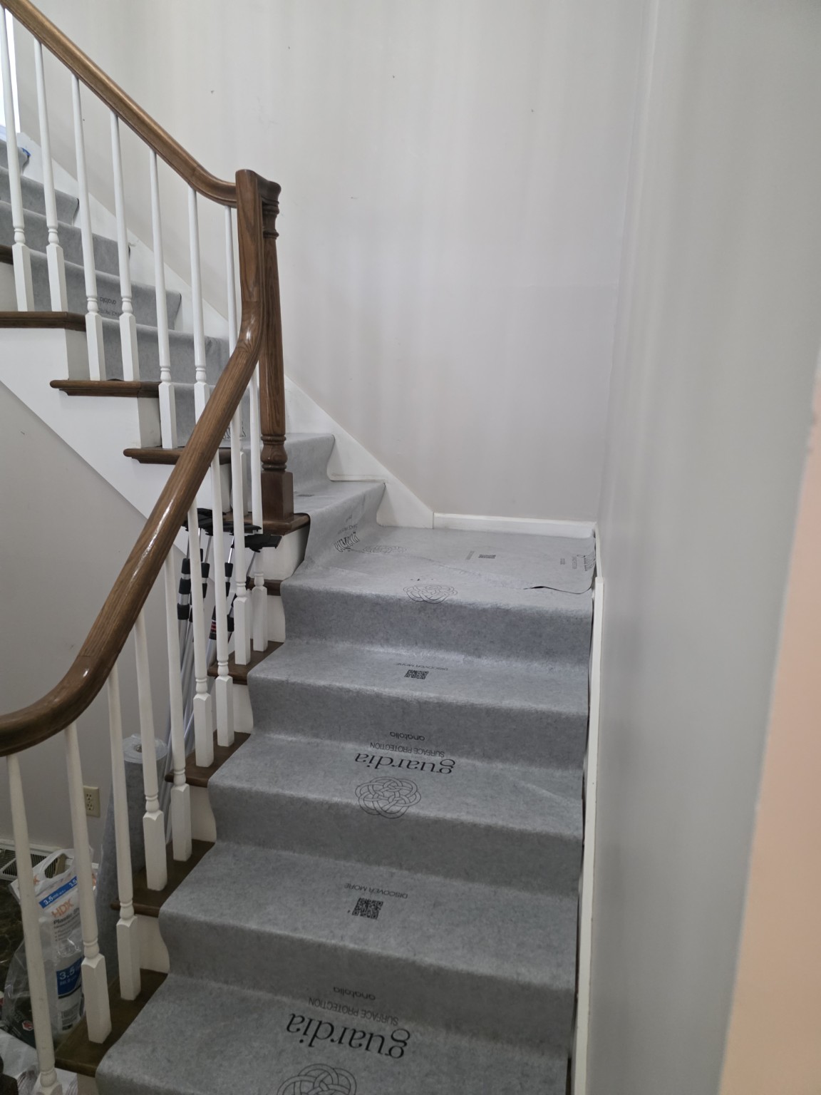 Protective floor covering laid over residential stair treads before demolition