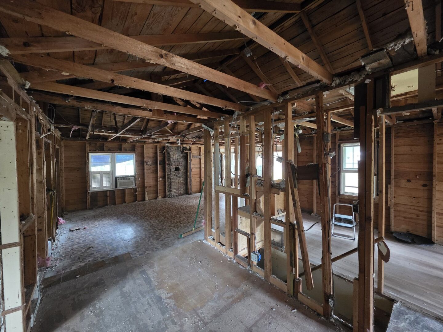 Interior room after selective demolition with wall framing exposed
