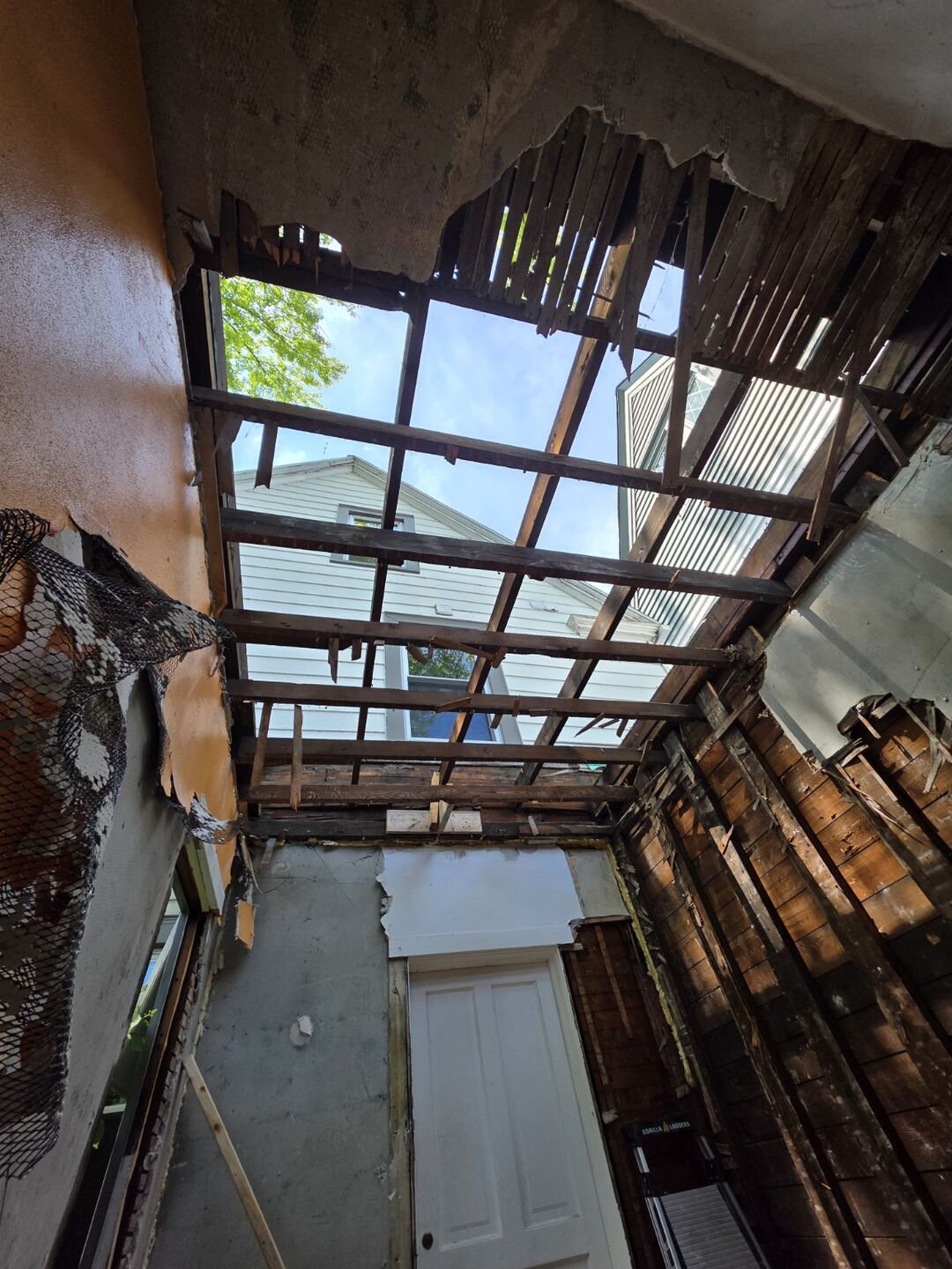 Exposed roof framing during removal work